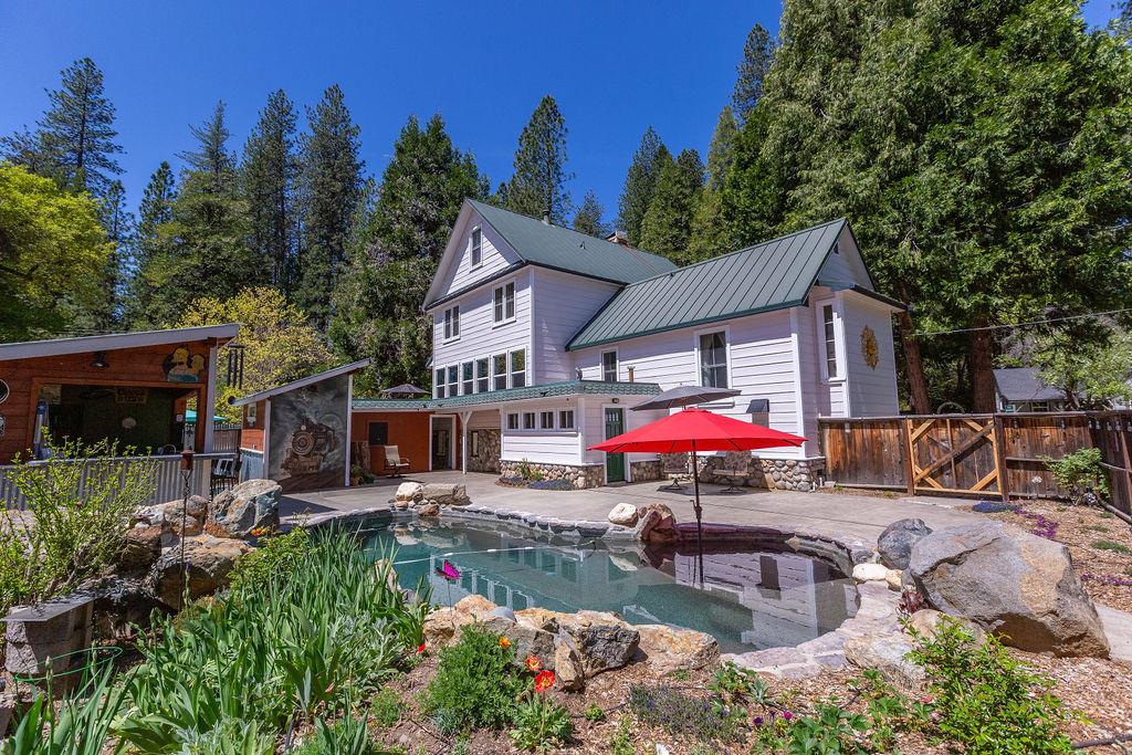 an outdoor space with lots of furniture and barbeque oven