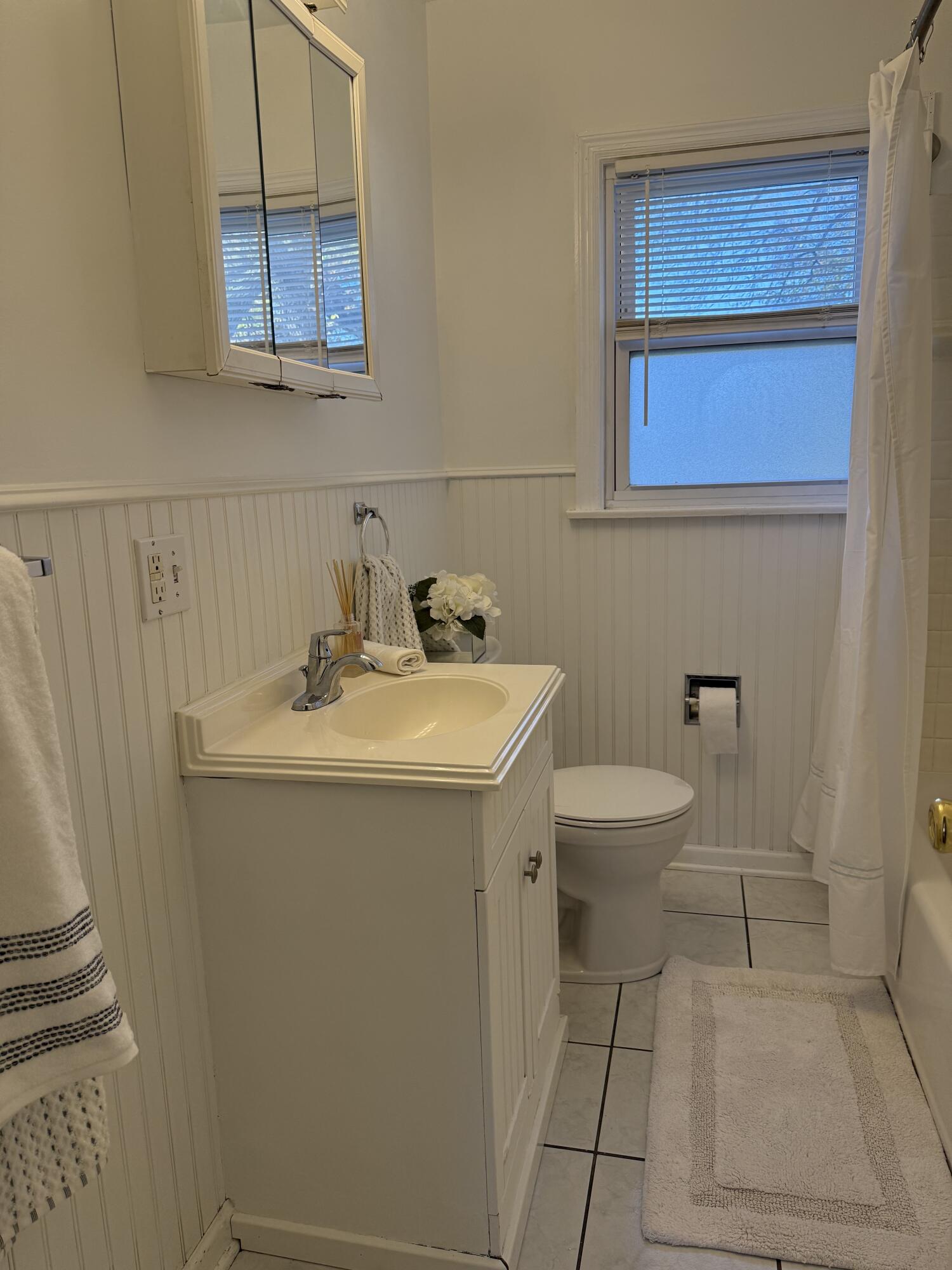 a bathroom with a sink toilet and mirror