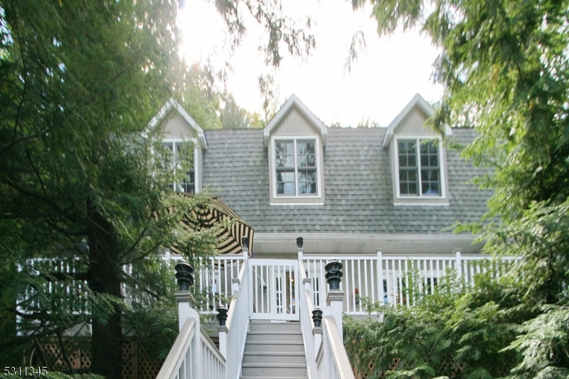 a view of house with a yard and sitting area