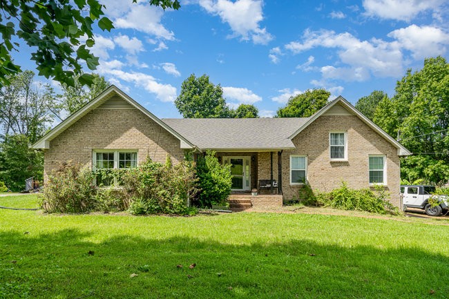 a front view of house with yard and green space