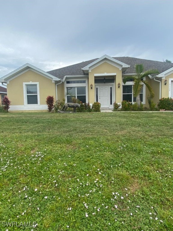 a front view of a house with a garden