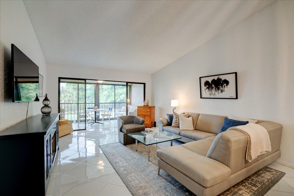 a living room with furniture large window and a flat screen tv