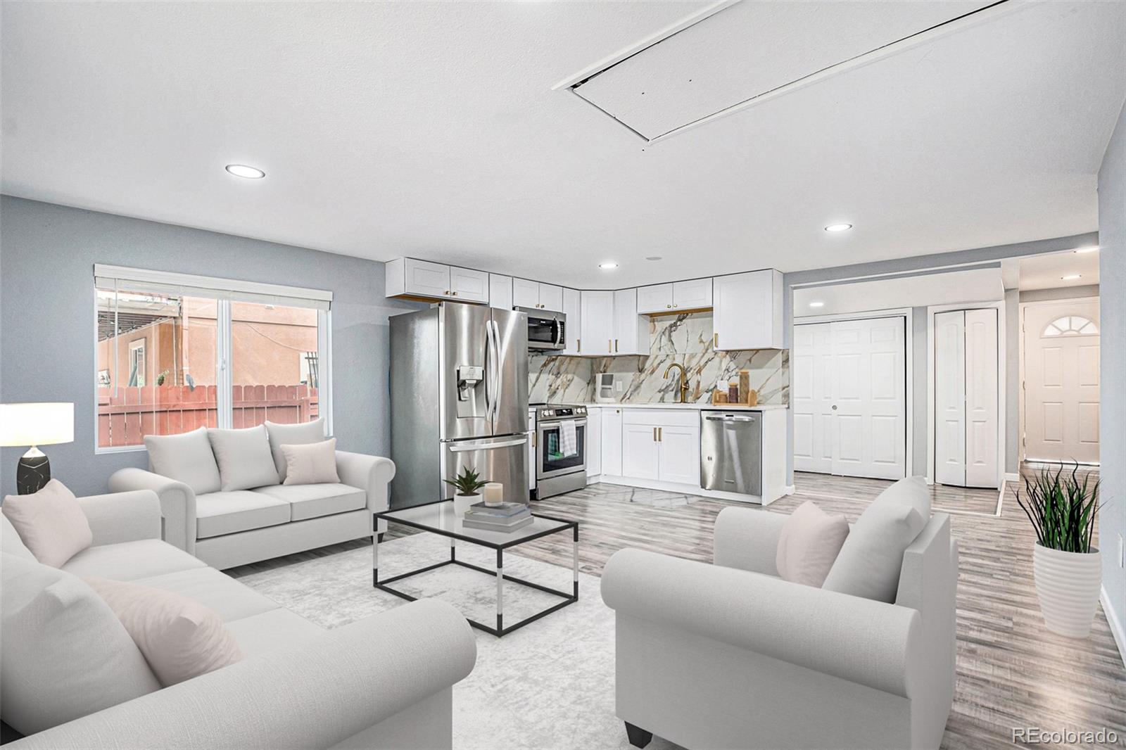 a living room with furniture and kitchen view