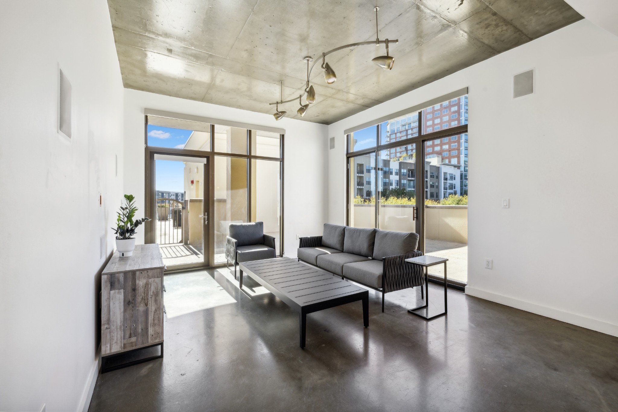 a living room with furniture a wooden floor and a window