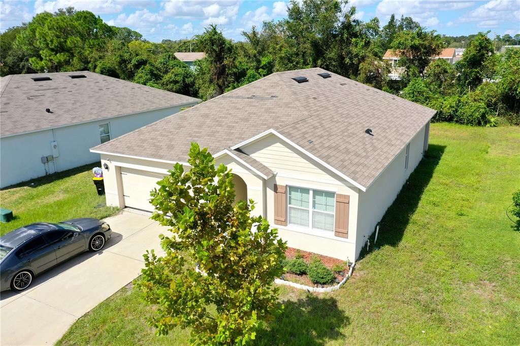 a view of a house with a yard and garage