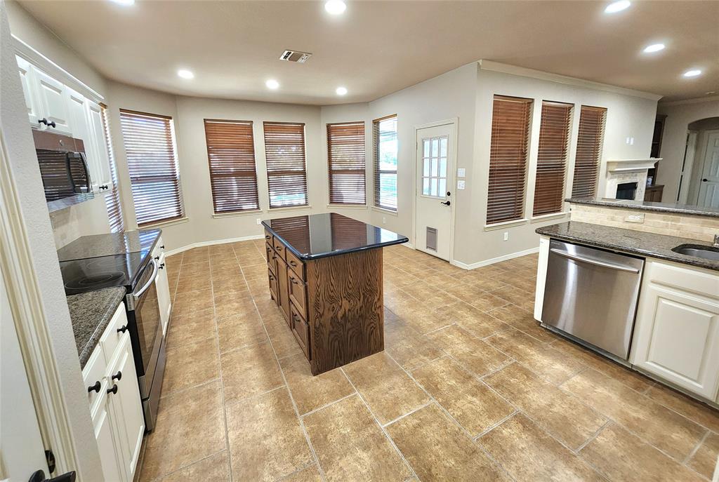 a view of a kitchen with a sink outdoor cabinets and wooden floor