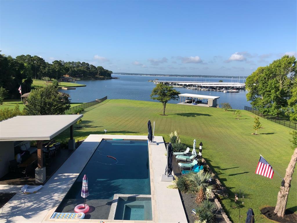 Direct lakefront access across from the Seven Coves Marina means not only one of the best views on Lake Conroe but protection from the waves of the main body during peak season.