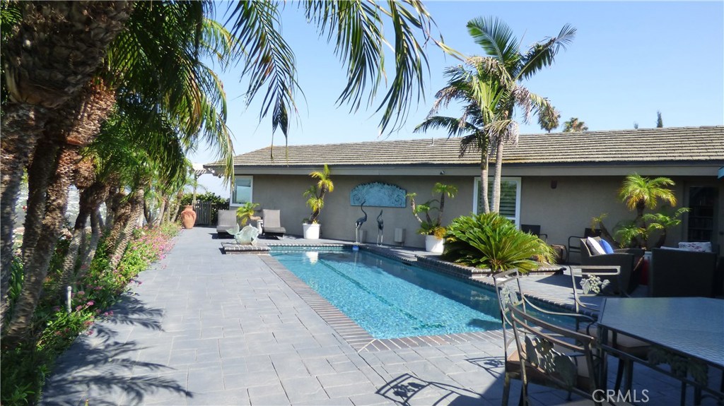 a view of a house with backyard and sitting area