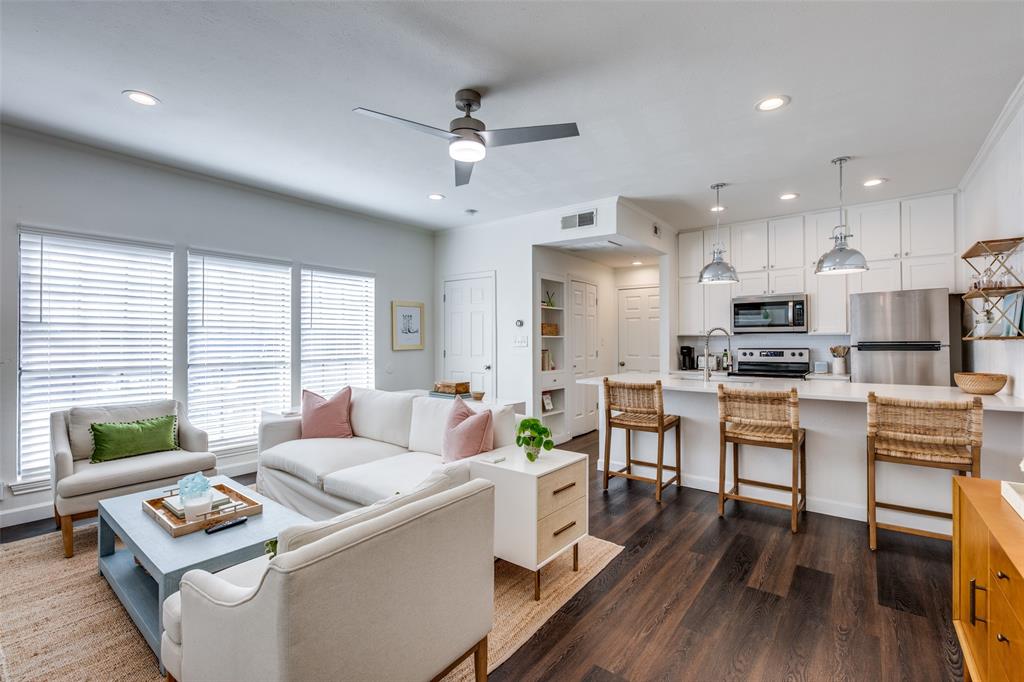 a living room with kitchen island furniture and a wooden floor