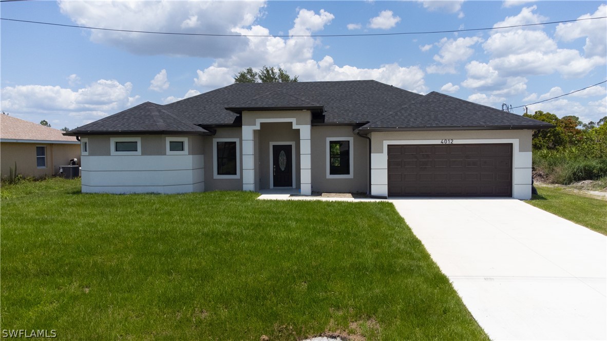 a front view of a house with a yard and garage