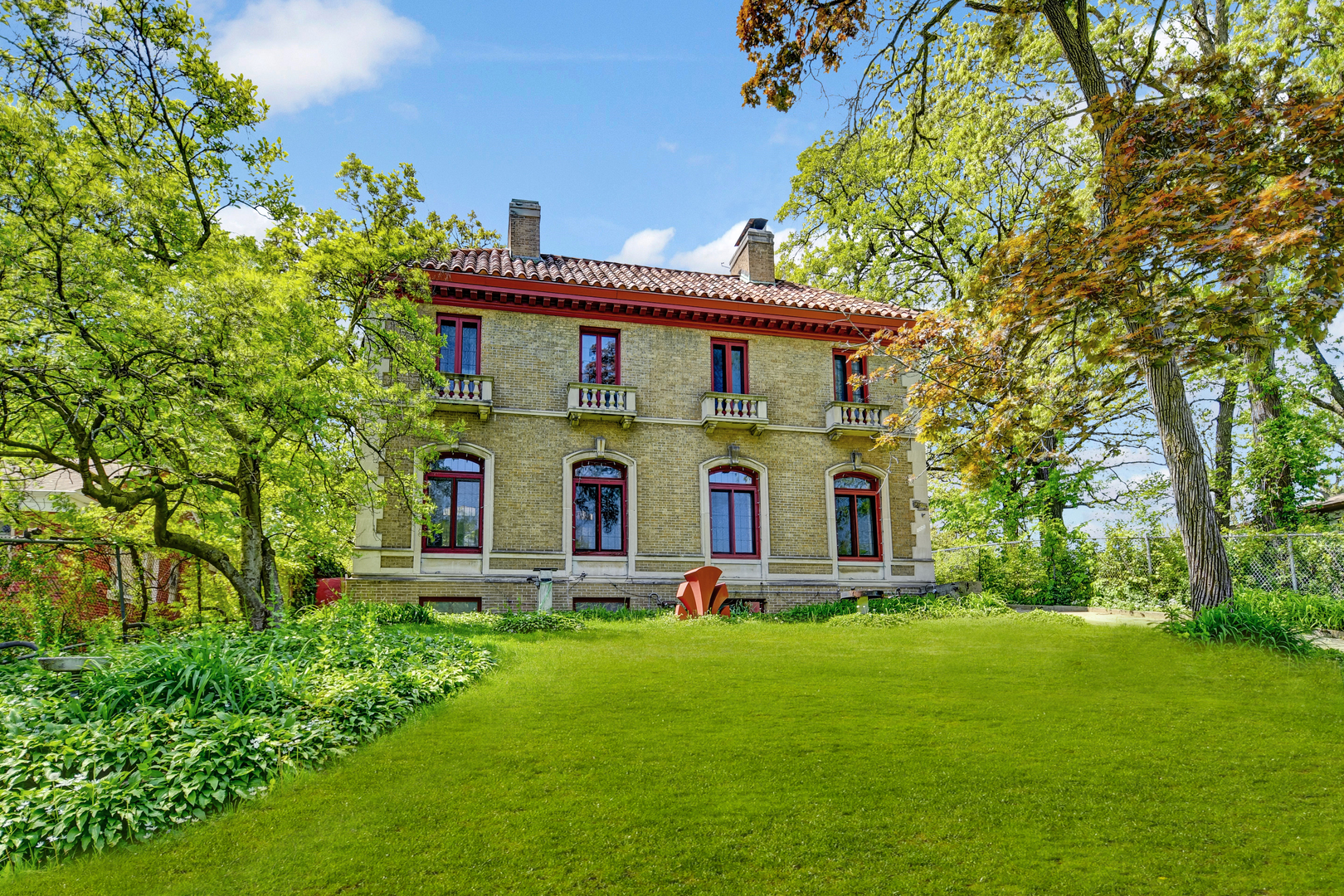 a front view of house with yard and green space