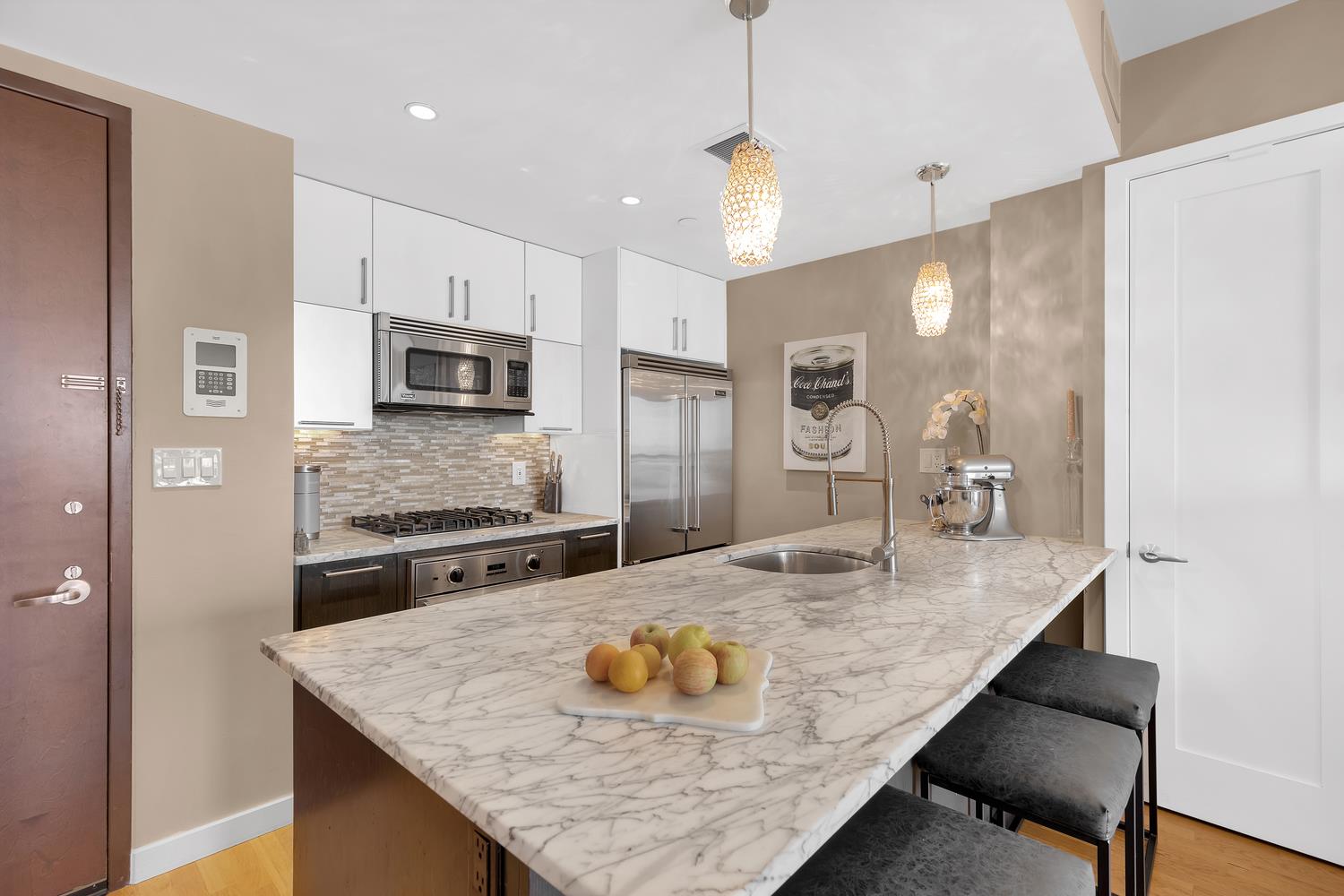 a kitchen with kitchen island a counter top space appliances and cabinets