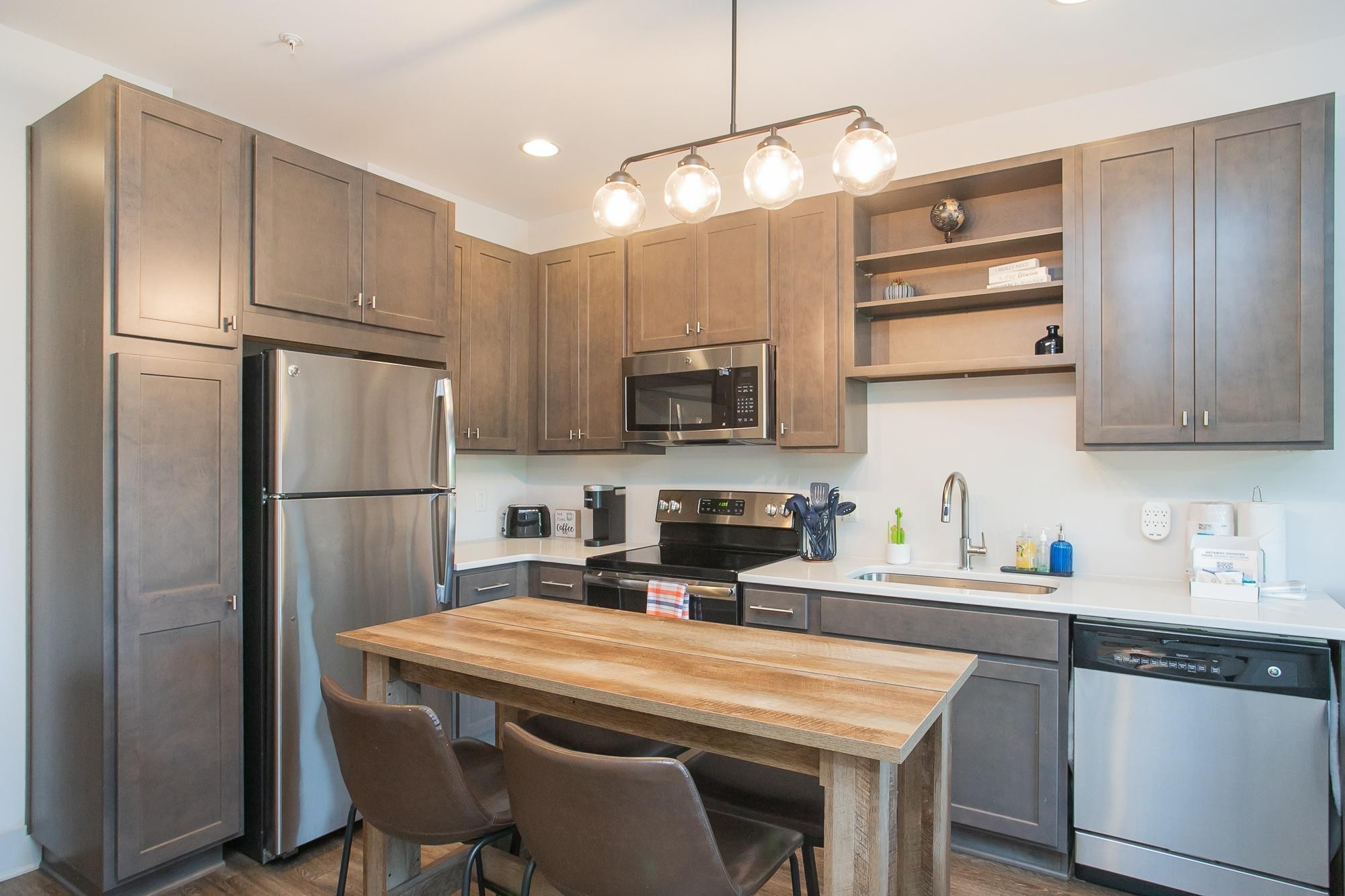 a kitchen with appliances a sink cabinets and a counter top space