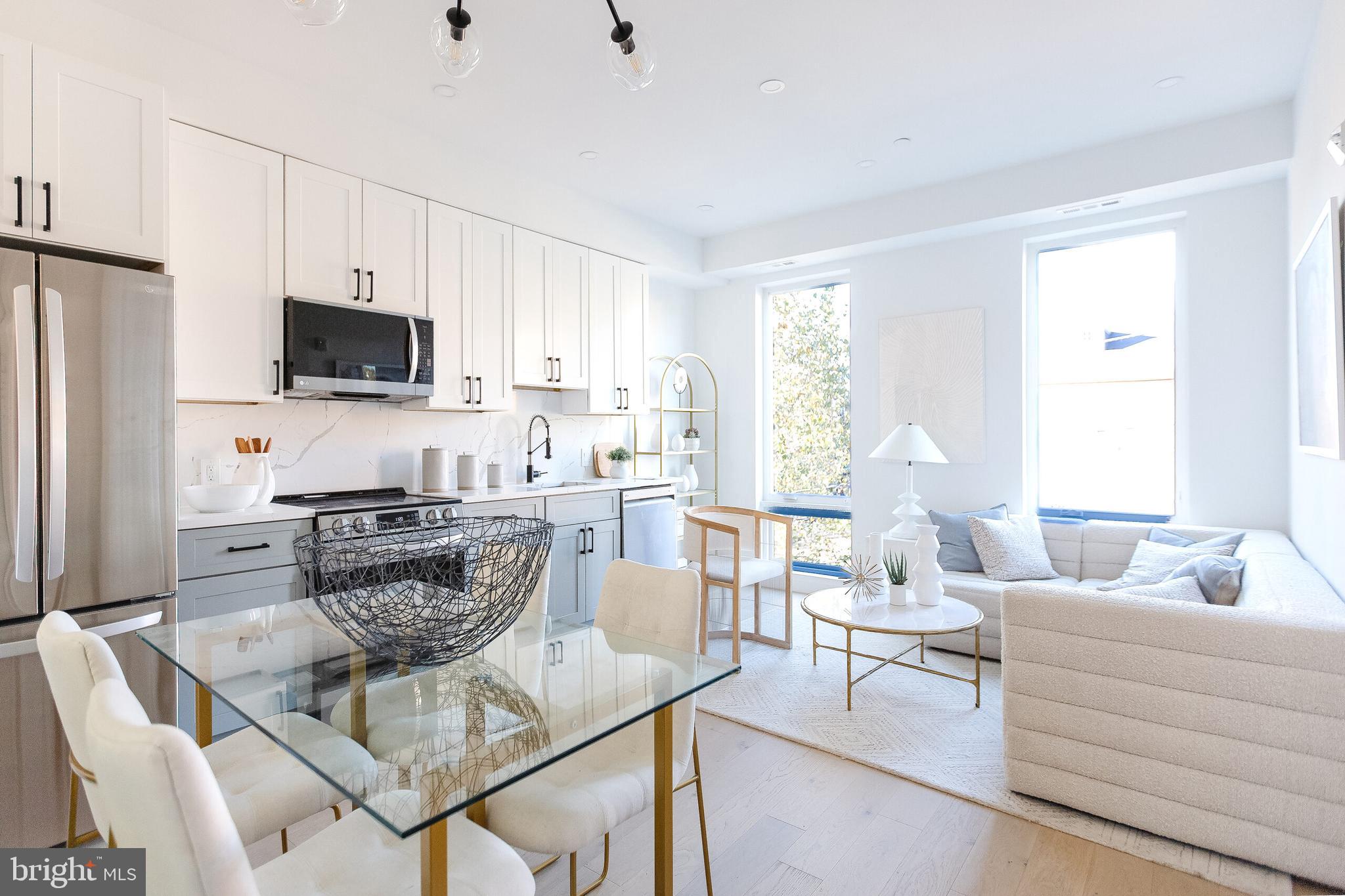 a living room with furniture a flat screen tv and a window