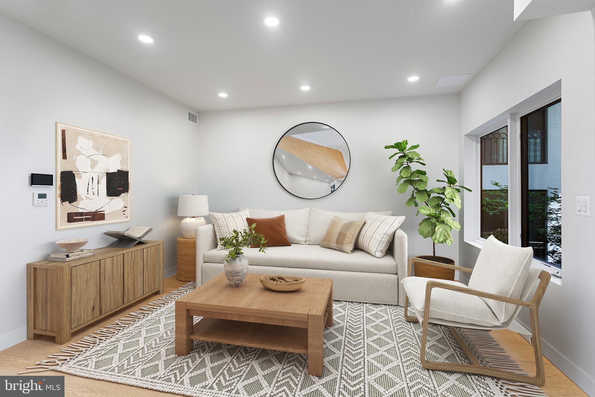 a living room with furniture a rug and white walls