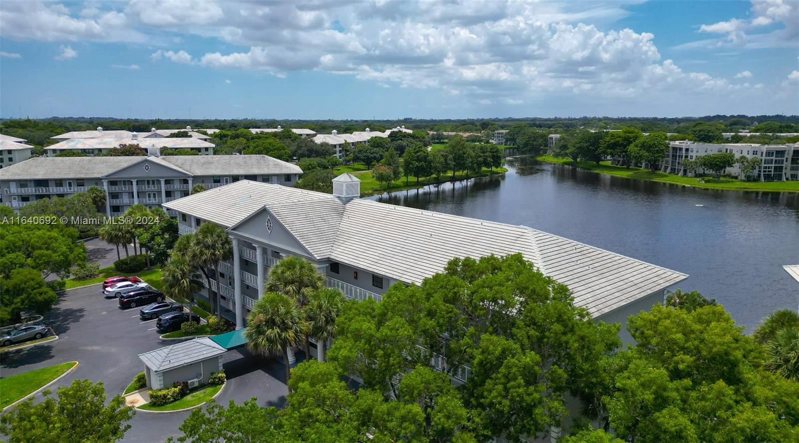 an aerial view of a house with a yard and lake view