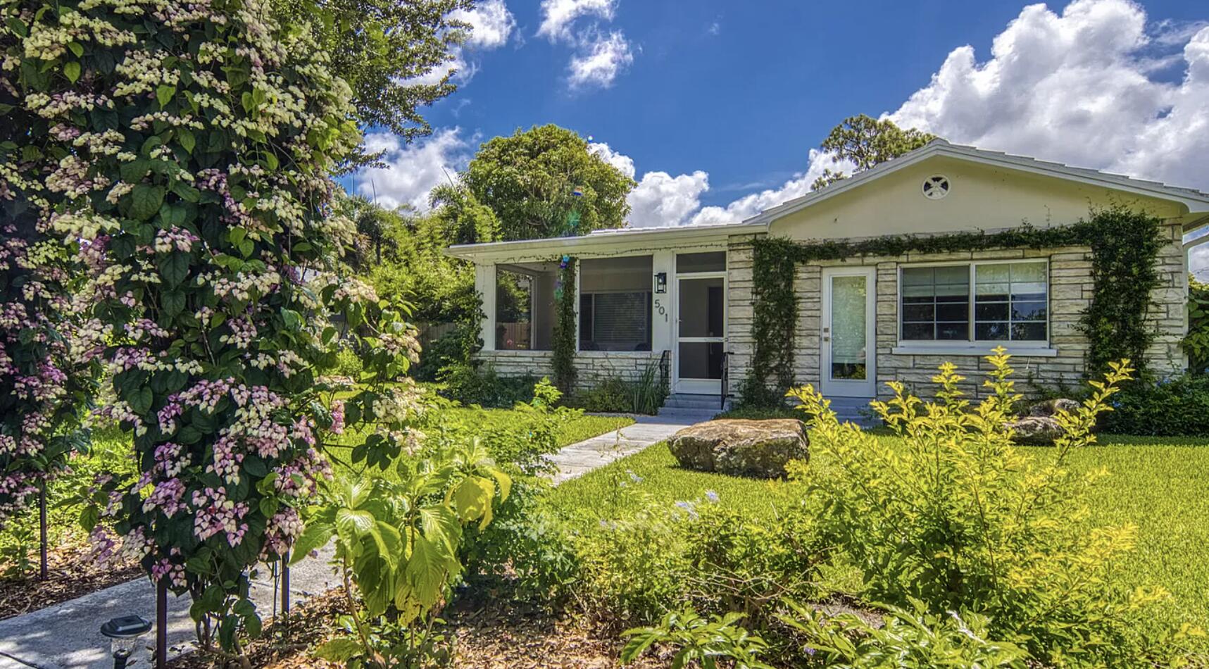 a front view of a house with garden