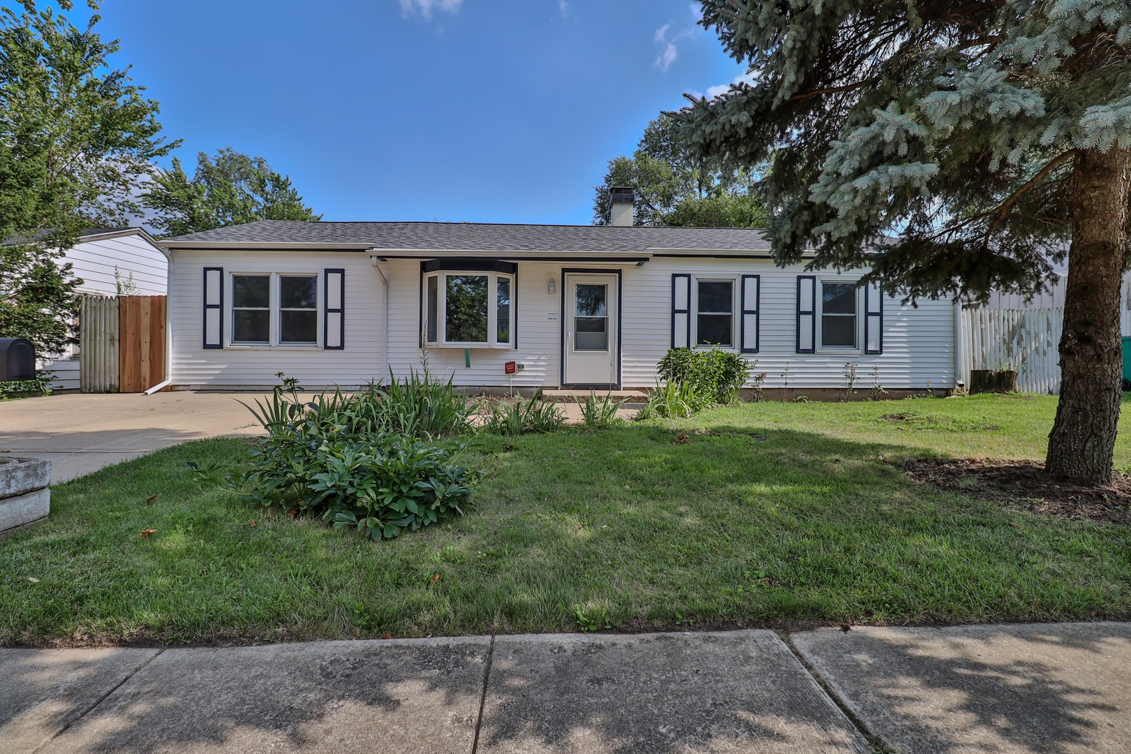 a front view of house with yard and green space