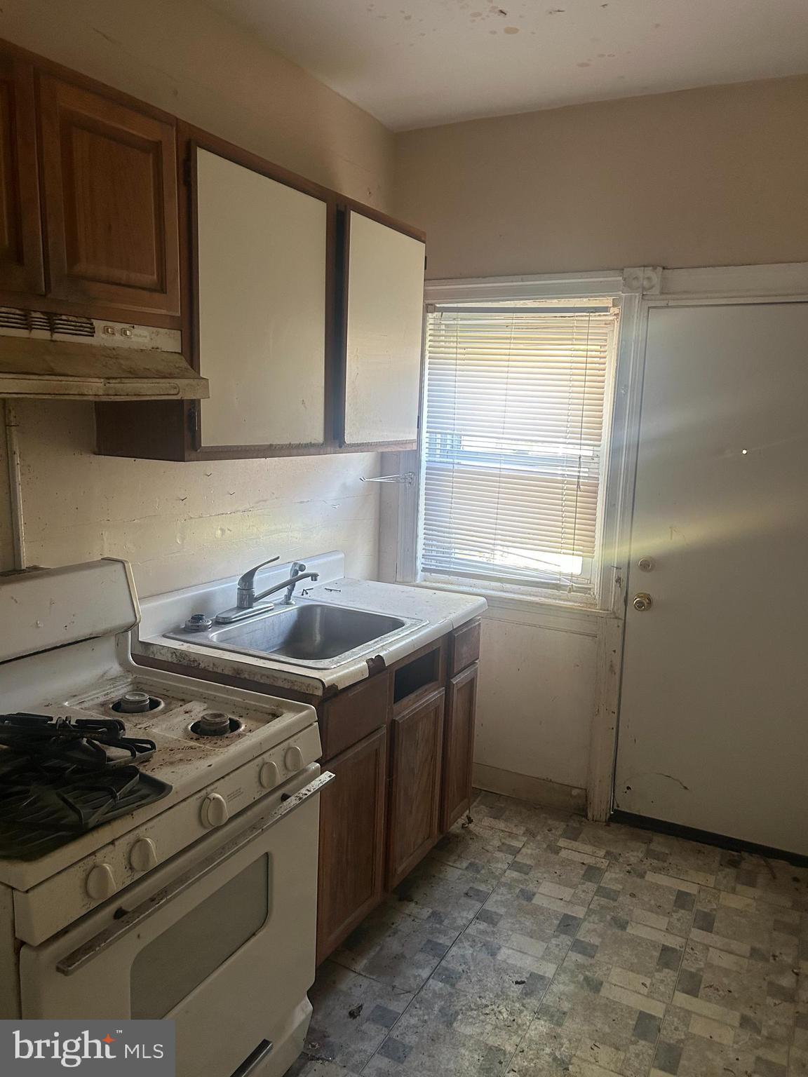 a stove top oven sitting inside of a kitchen