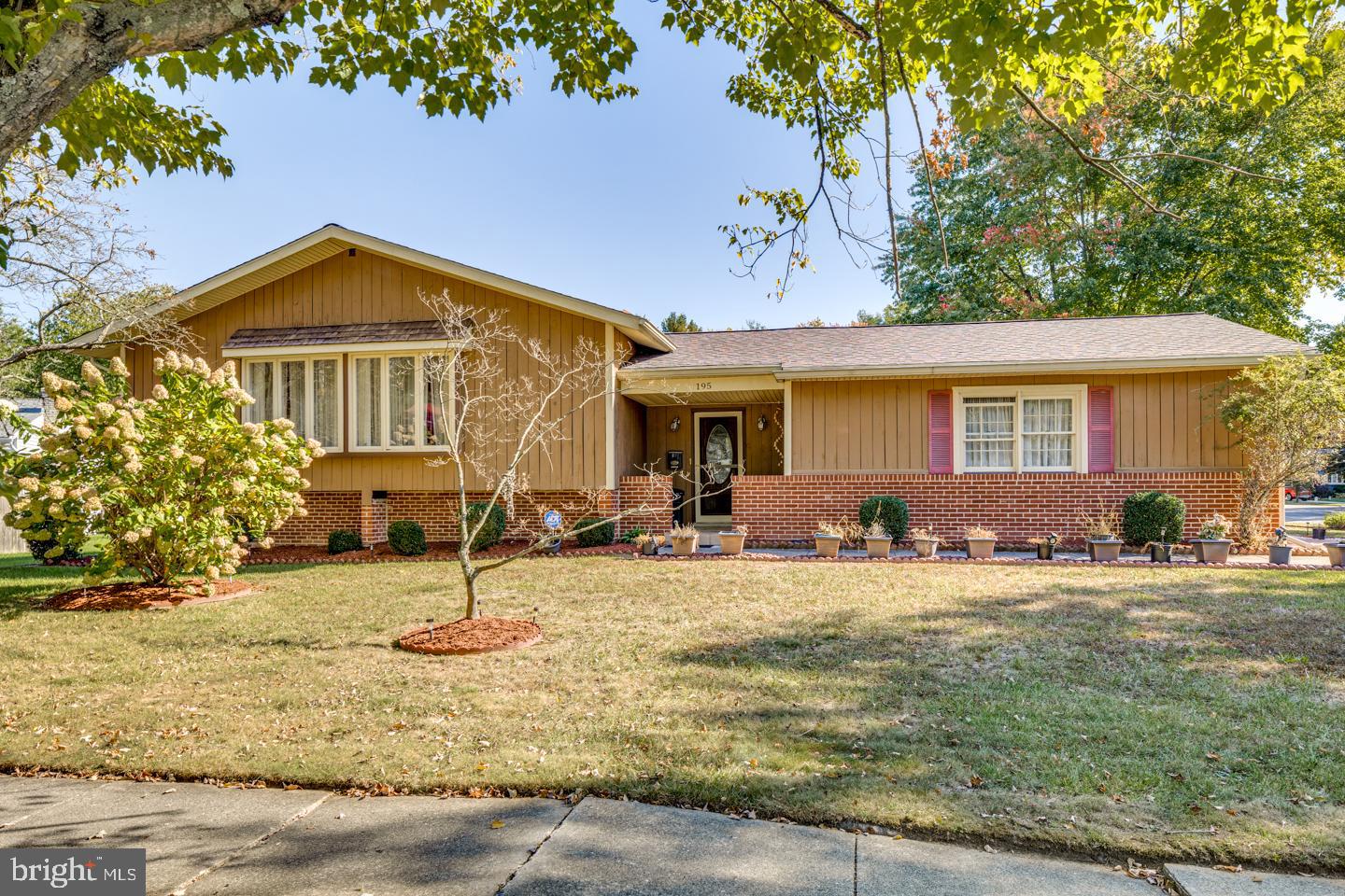 a view of a house with a yard and sitting area