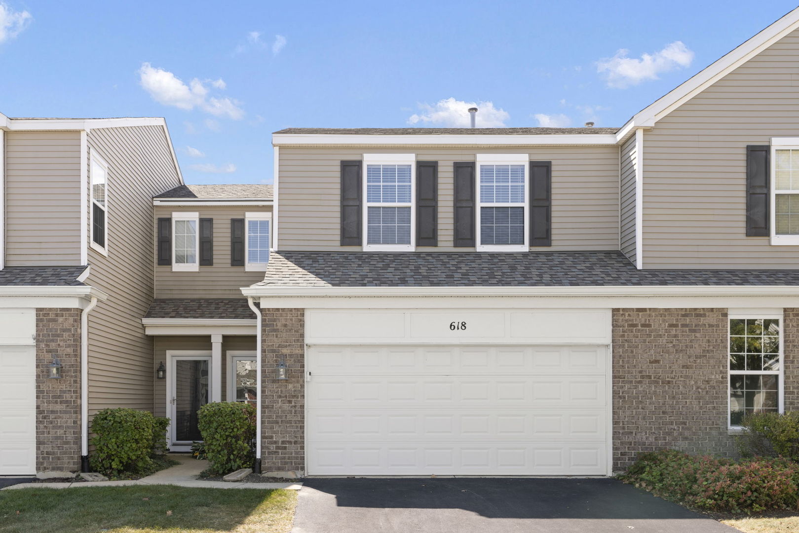 a front view of a house with a yard