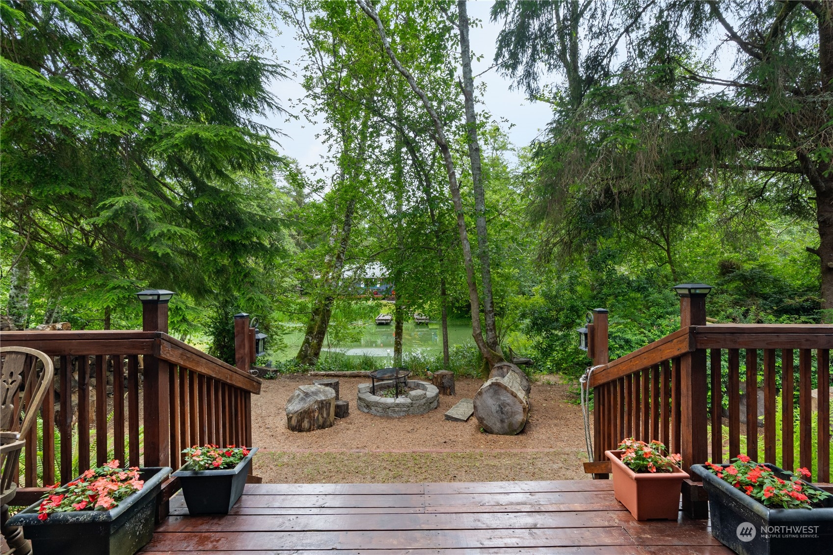 a view of a deck with a table and chairs with wooden floor and fence