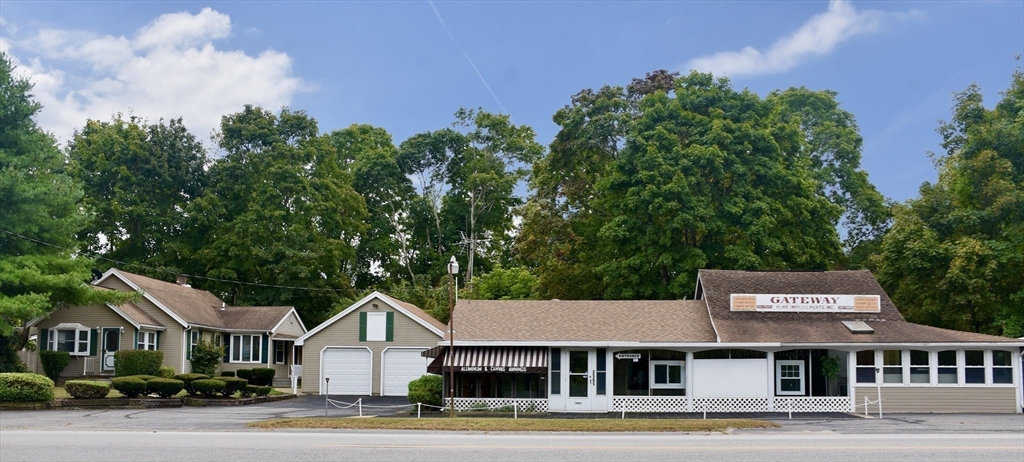 a view of a big house with a big yard and large trees