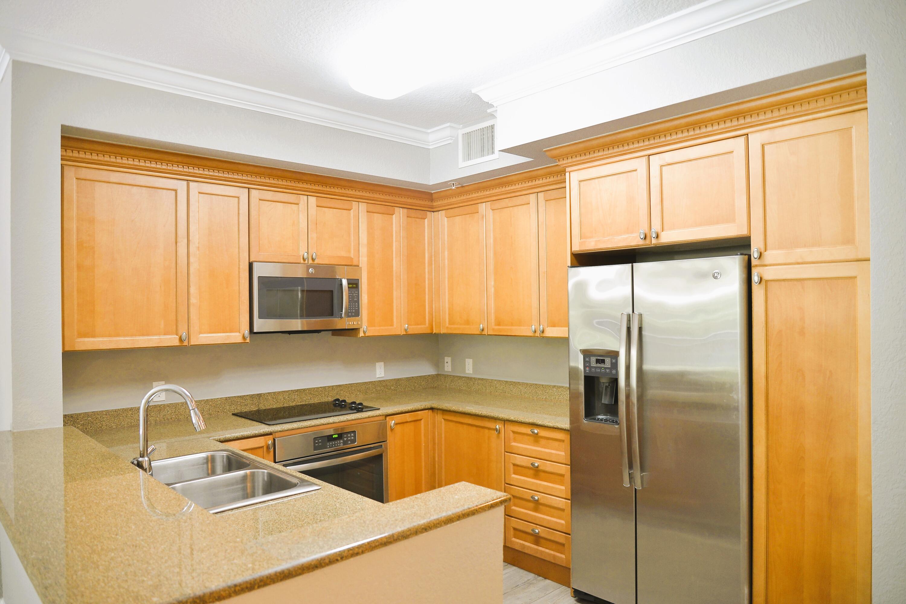 a kitchen with a refrigerator a sink and a window