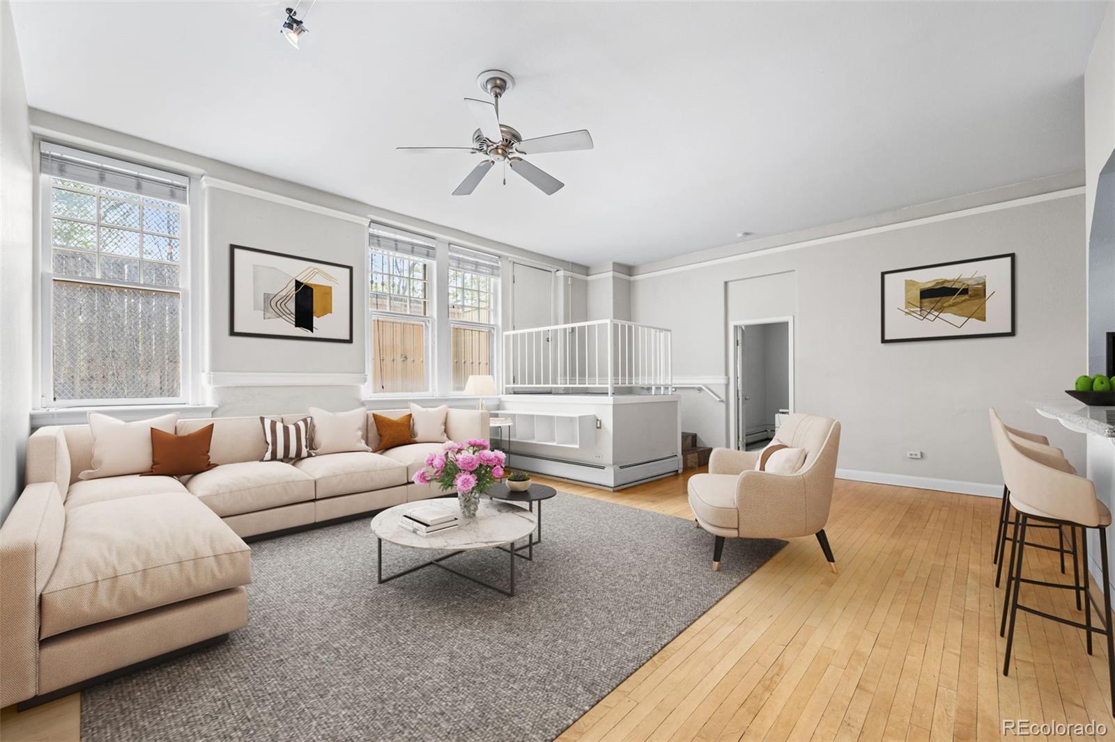 a living room with furniture and wooden floor