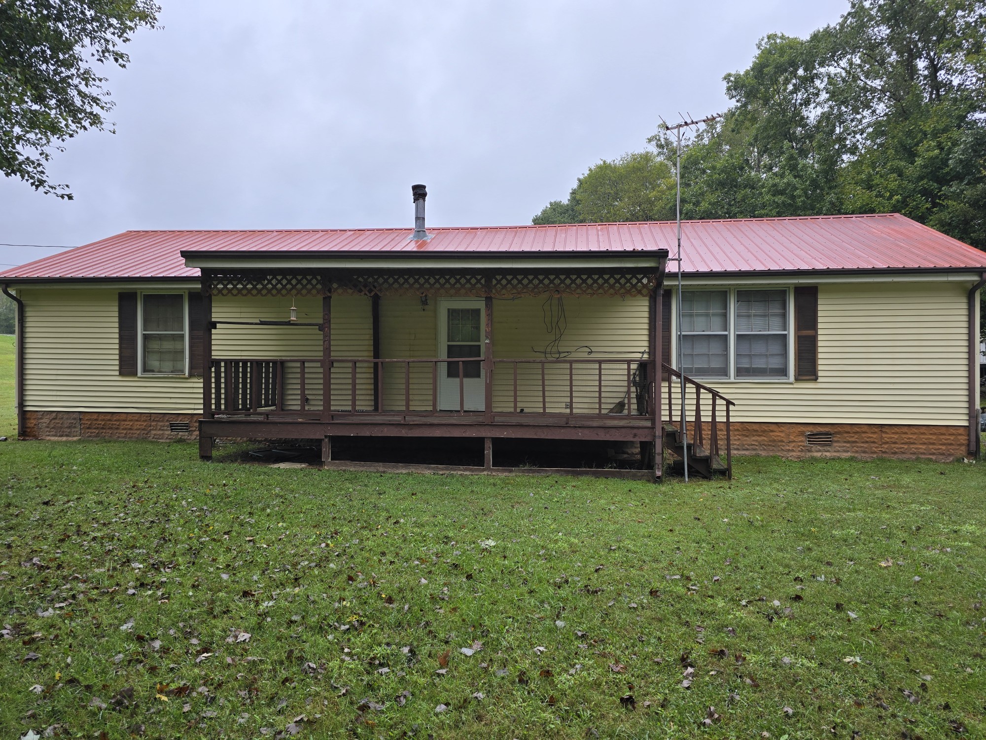 a view of a house with a yard and sitting area