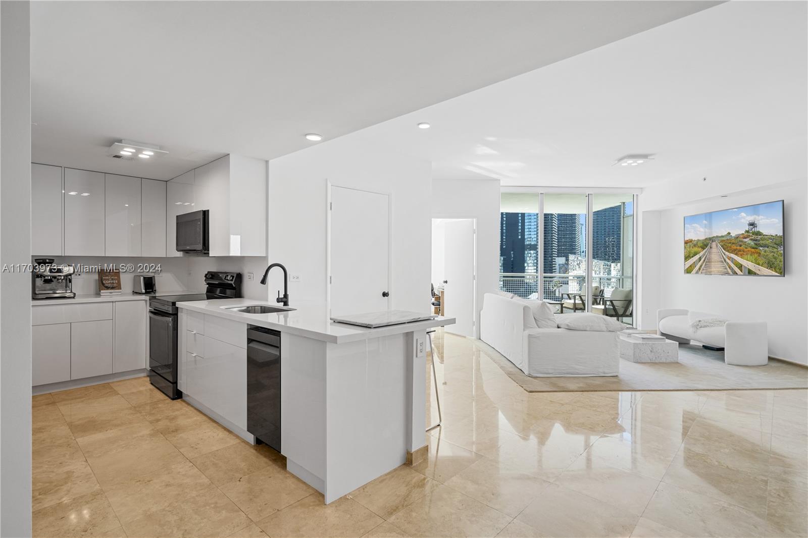 a view of kitchen with sink a microwave and refrigerator