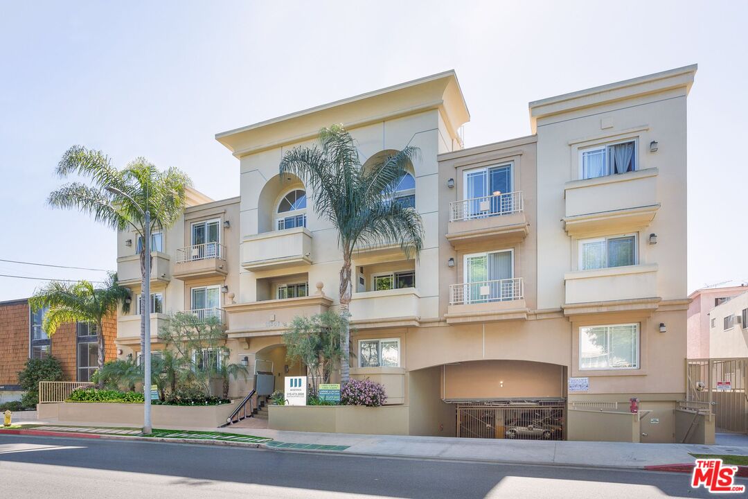 a front view of a residential apartment building with a yard