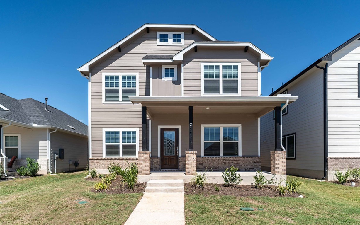 a front view of a house with yard and seating space