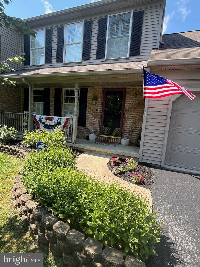 a front view of a house with a yard and outdoor seating