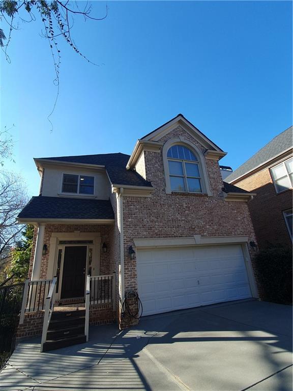 View of front of house with a porch and a garage