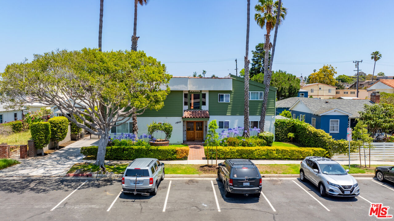 a couple of cars parked in front of a house