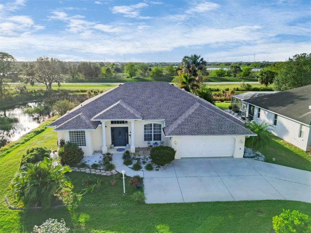 a aerial view of a house with a yard and a garden