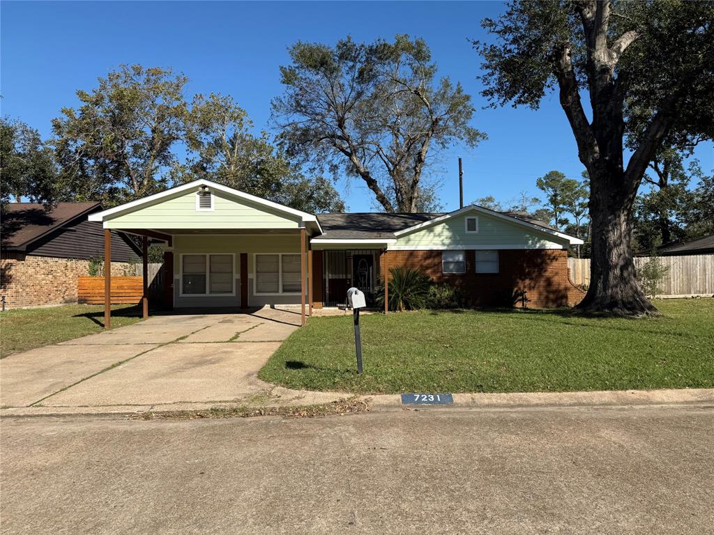 a front view of a house with a yard and trees