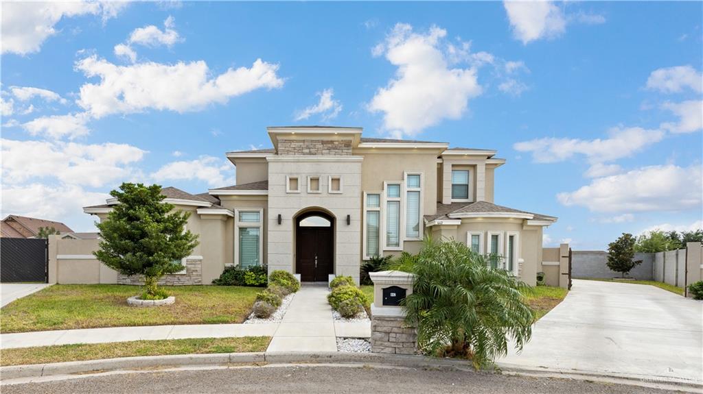 a front view of a house with a garden