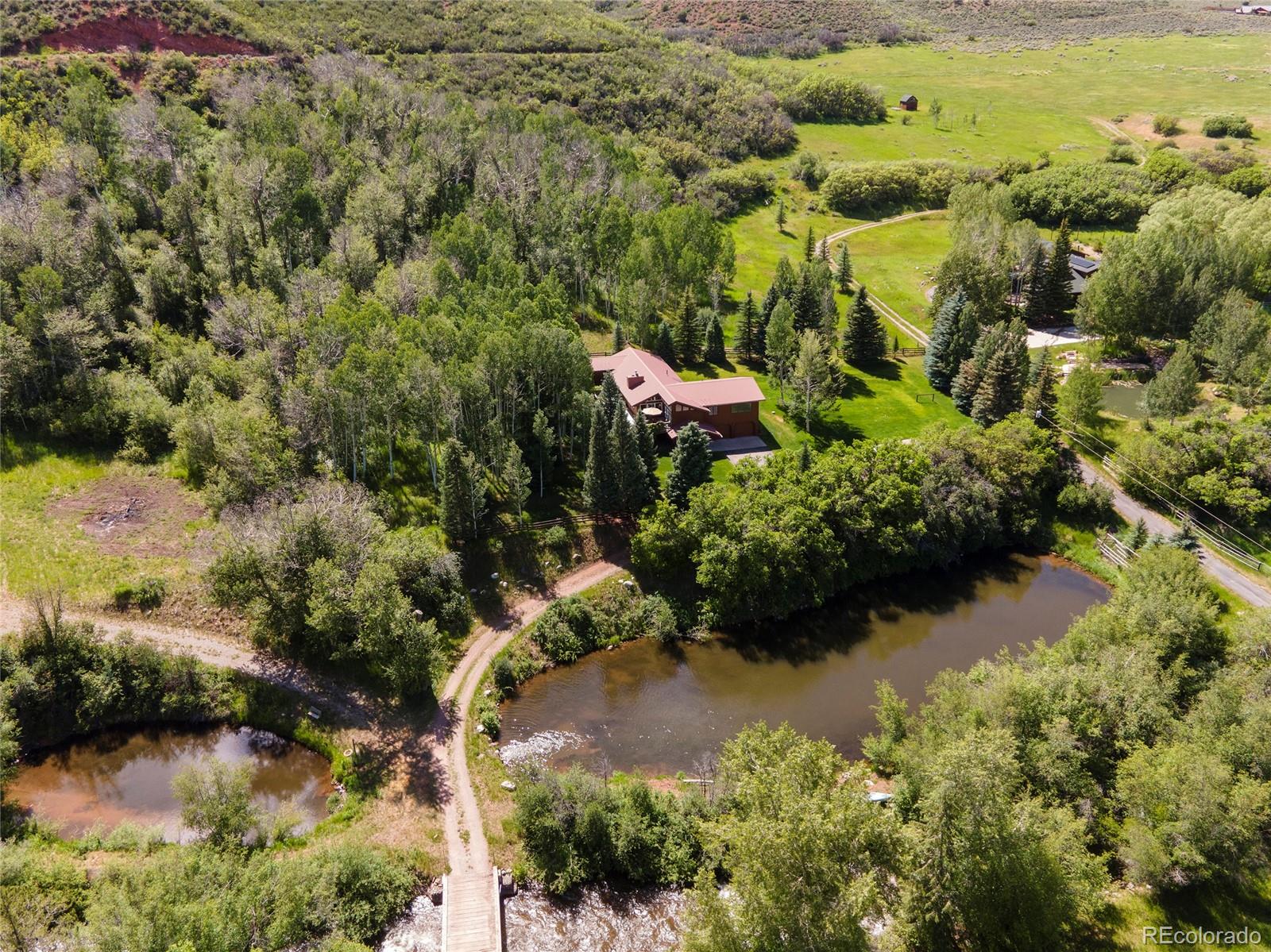 an aerial view of residential house with beach and outdoor space