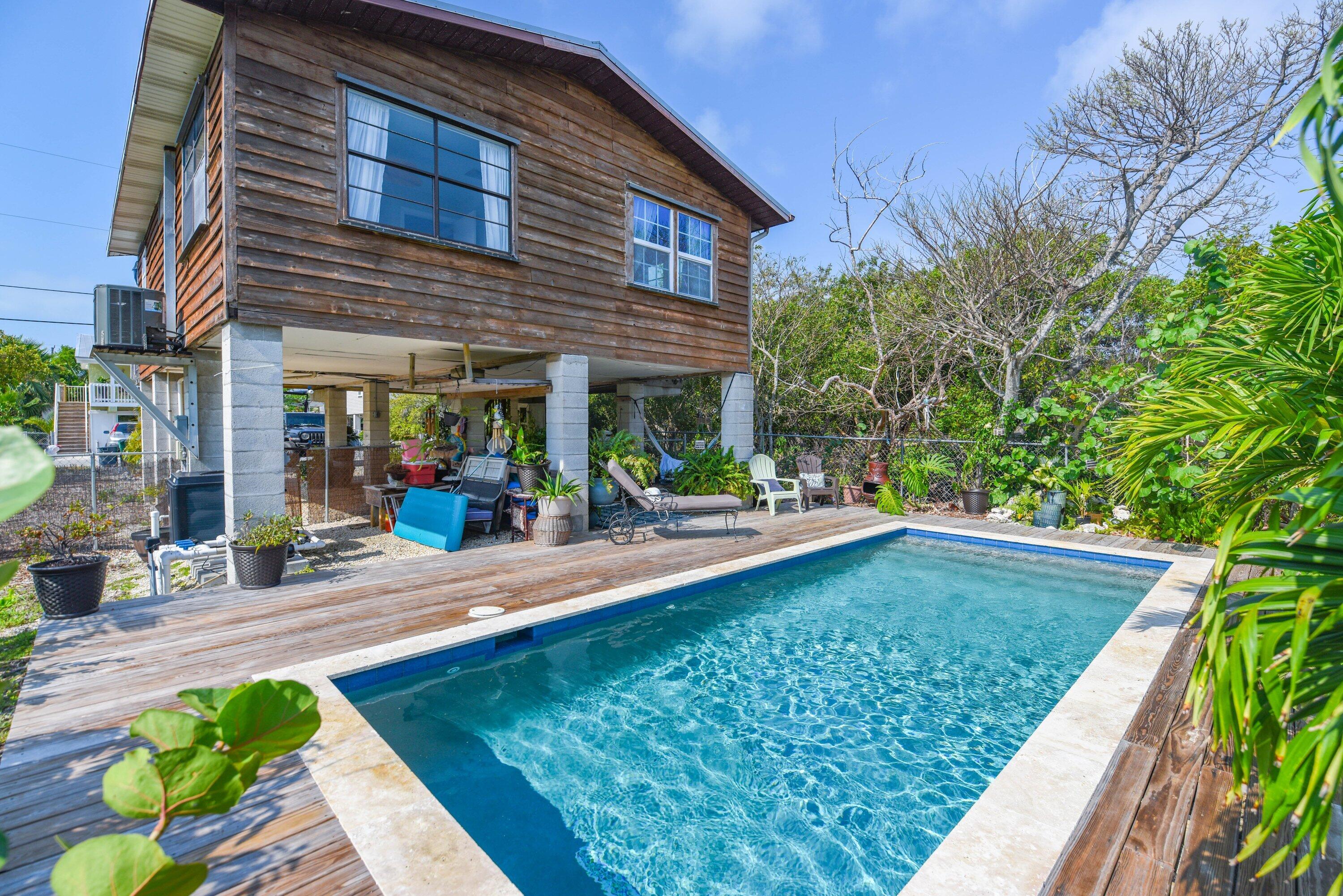 a view of a house with backyard porch and sitting area