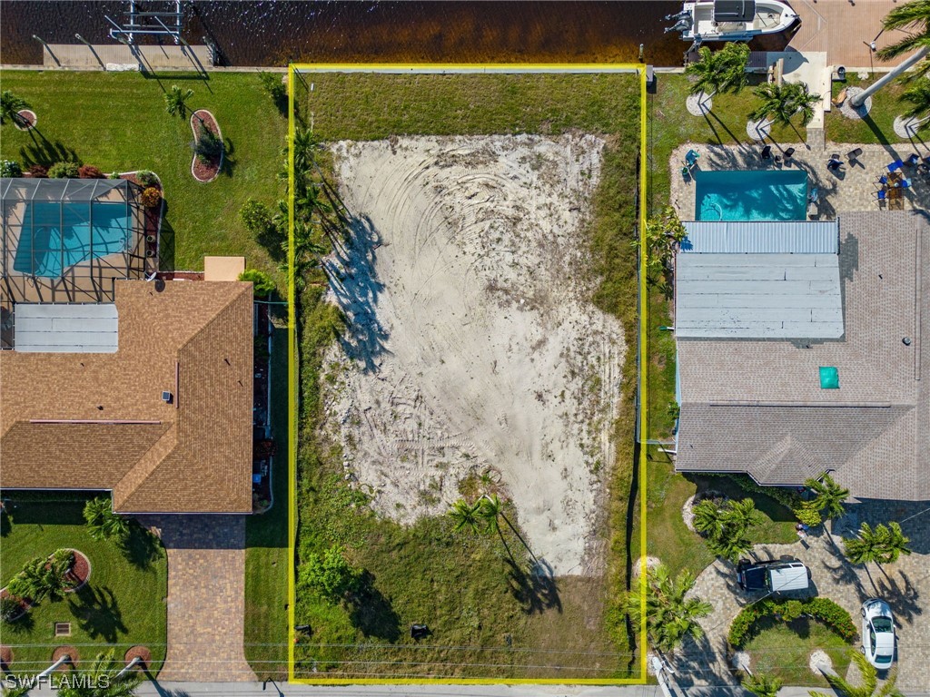 an aerial view of a house with a yard