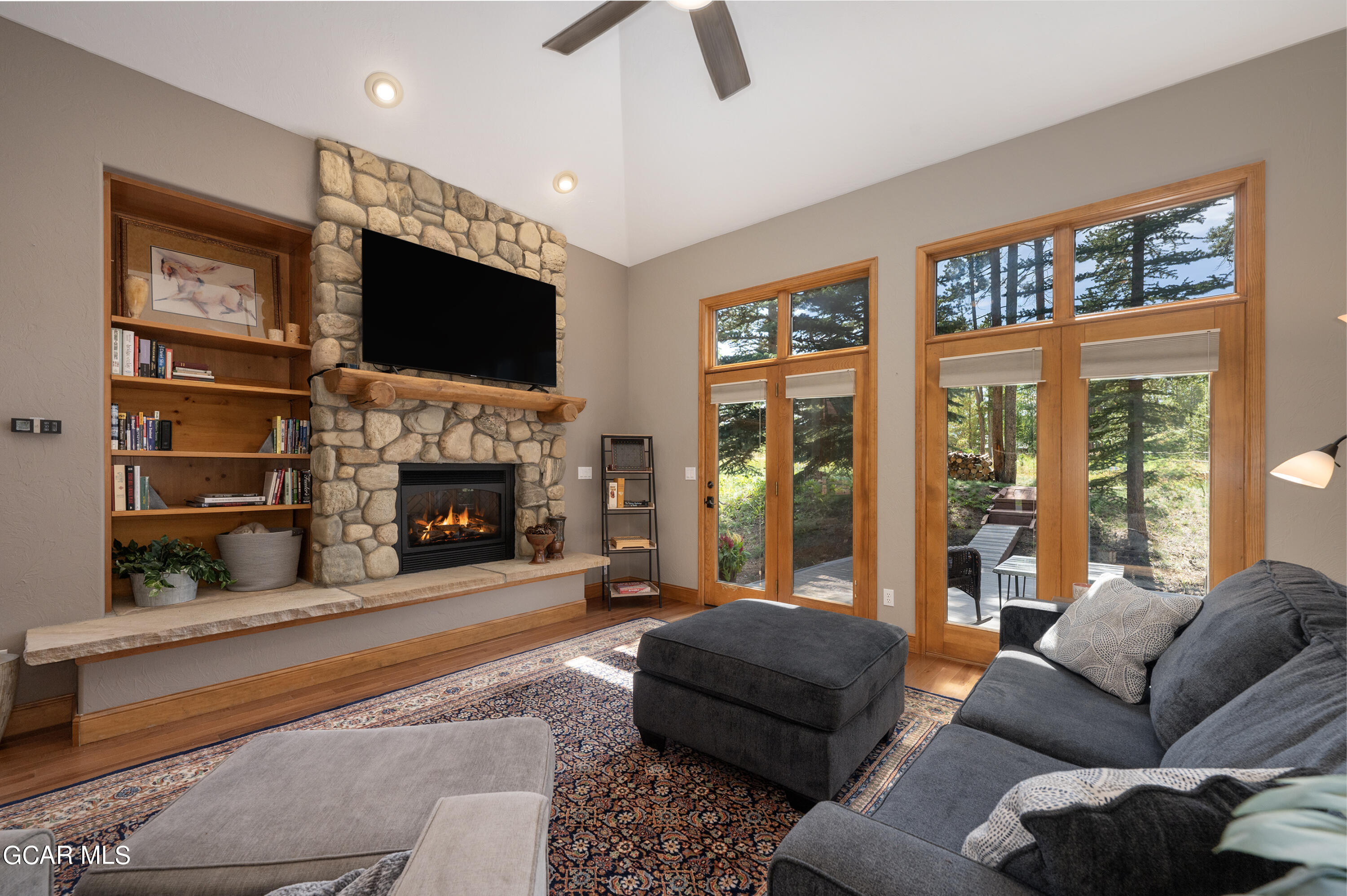 a living room with furniture a flat screen tv and a fireplace