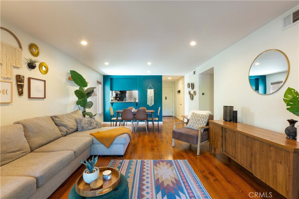 a living room with furniture and wooden floor