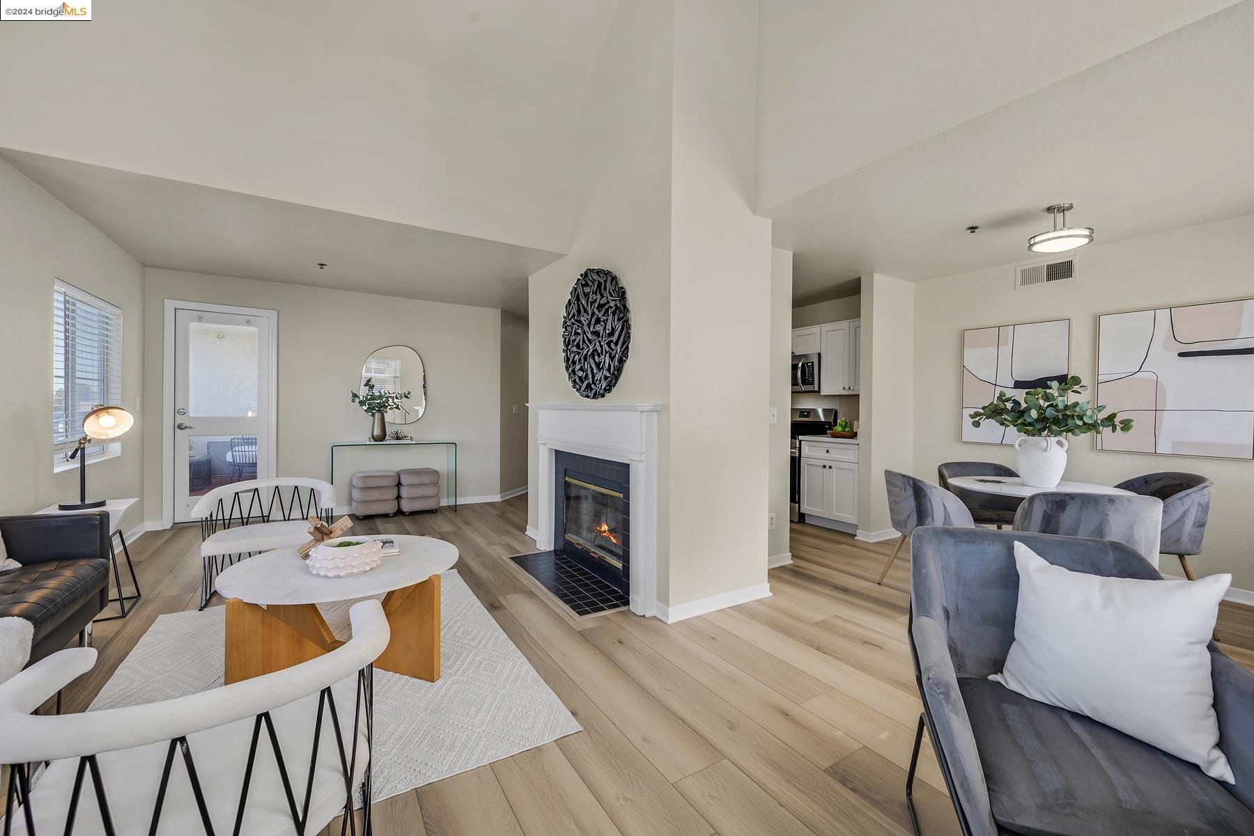 a dining room with furniture a fireplace and wooden floor