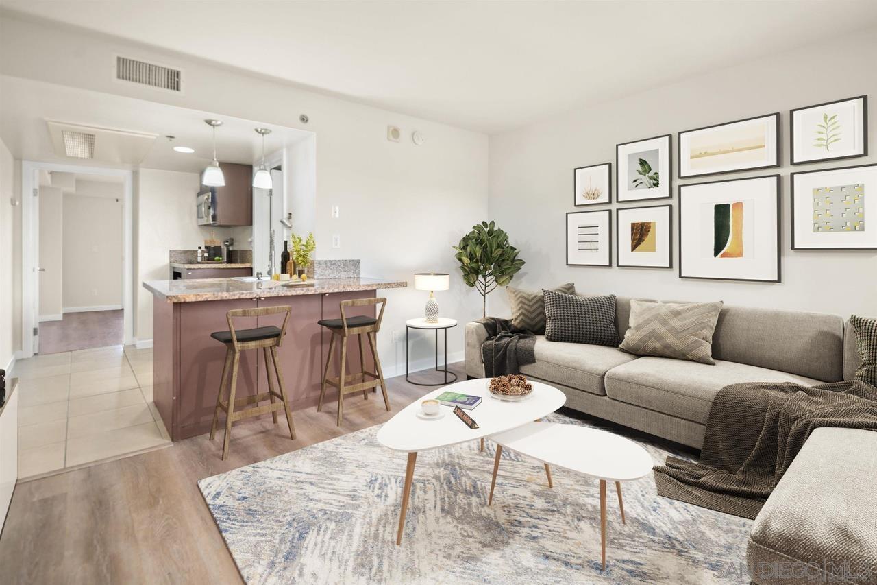 a living room with furniture kitchen view and a table