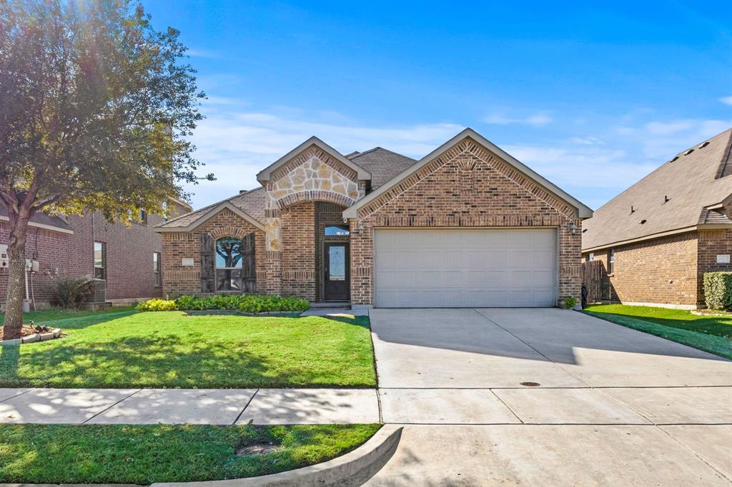 a front view of a house with a yard and garage