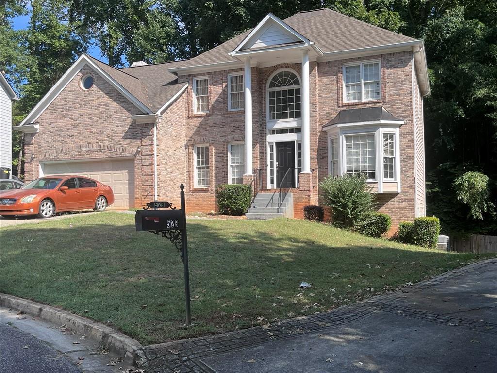 a front view of a house with a yard