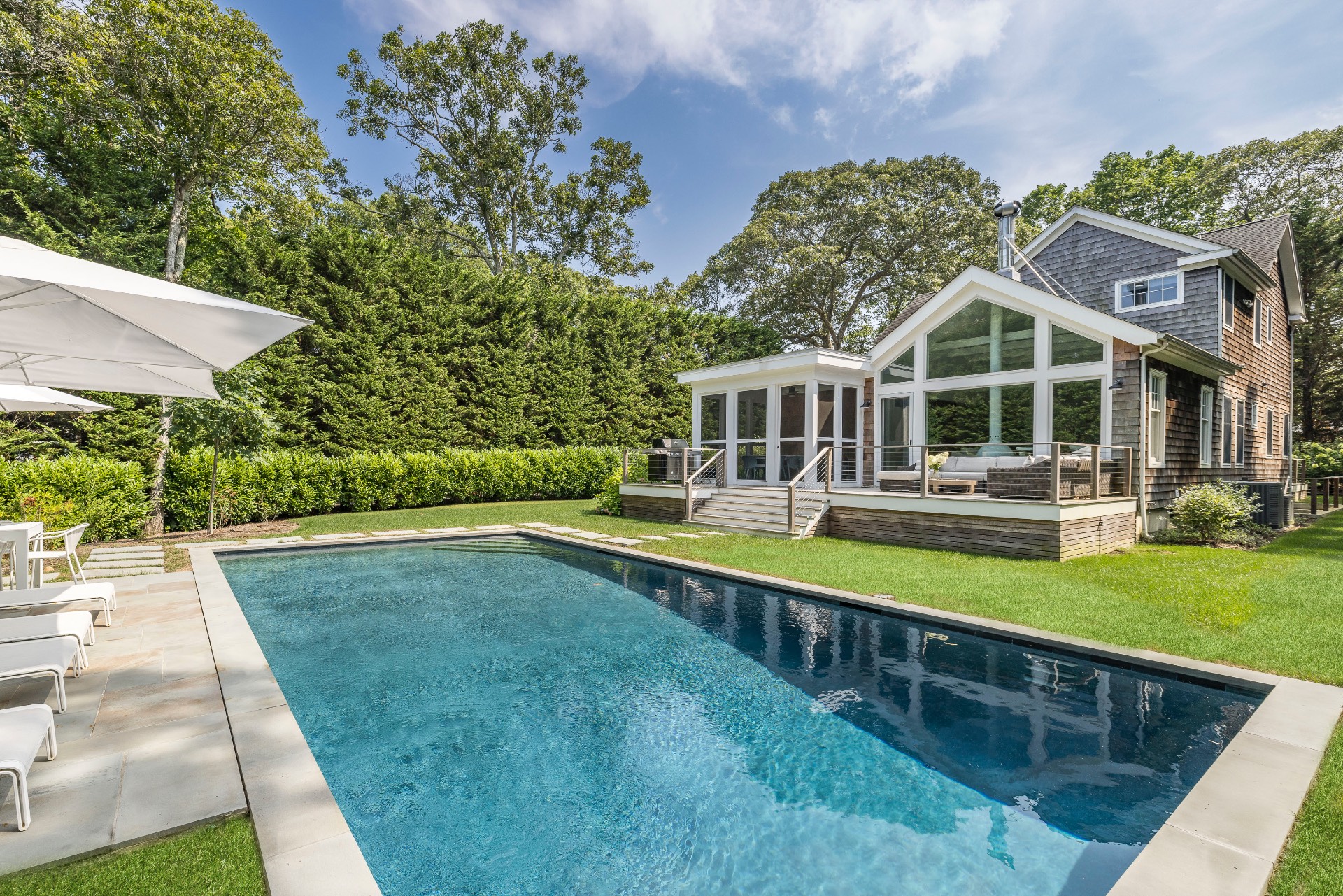 a view of an house with swimming pool and deck