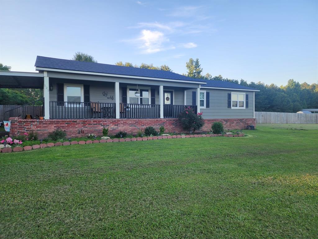 a view of front of house with a yard